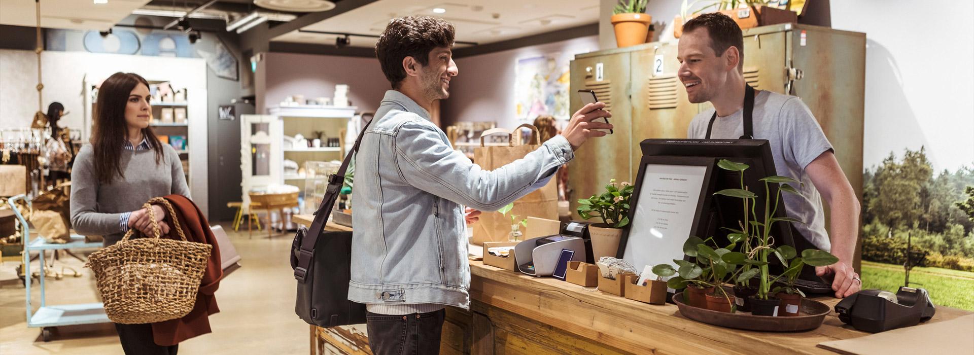 man and lady at counter making purchases