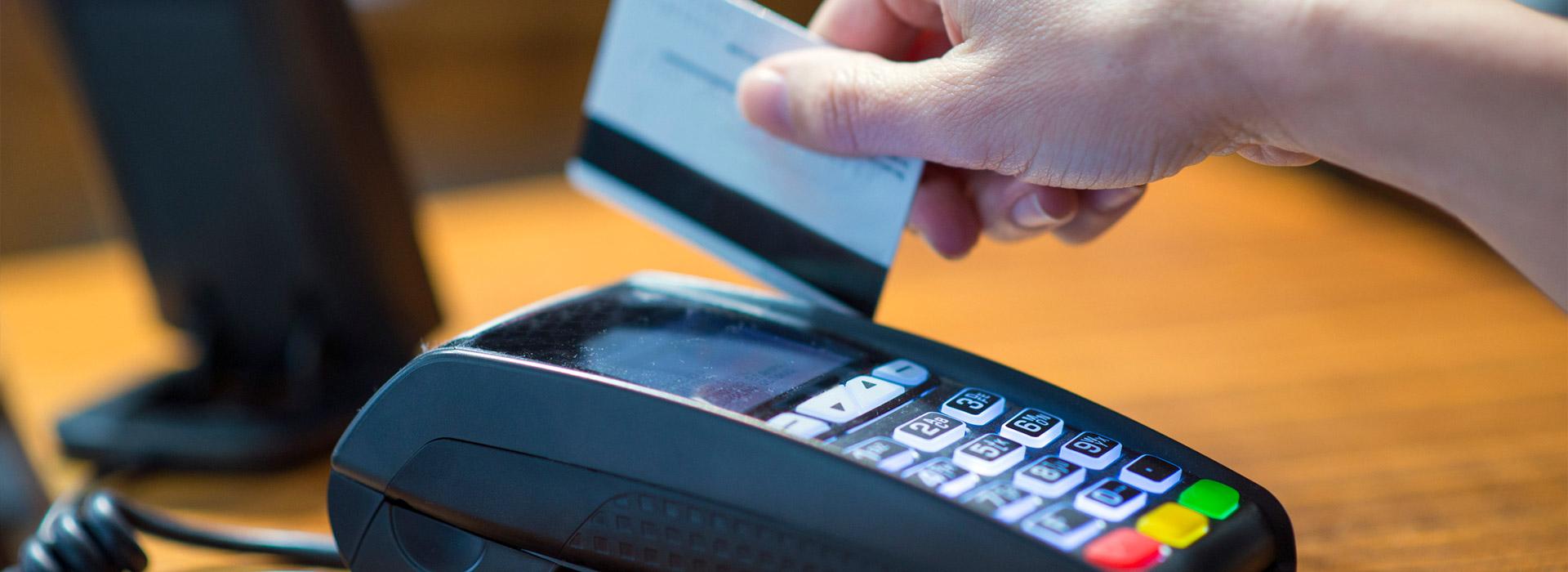 hand swiping a credit card