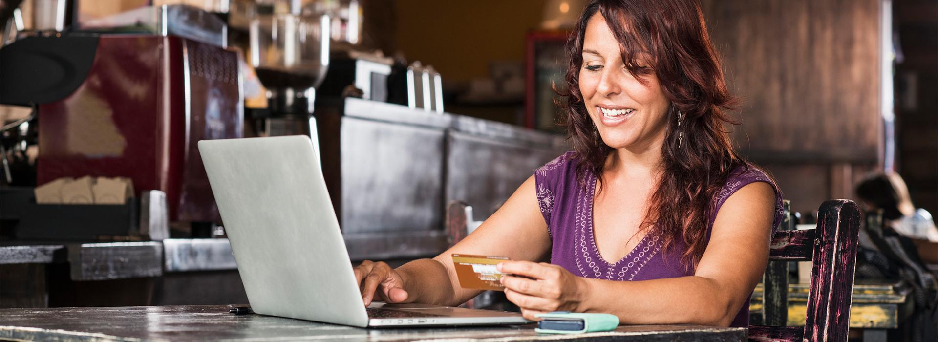 Woman at computer making a credit card transaction